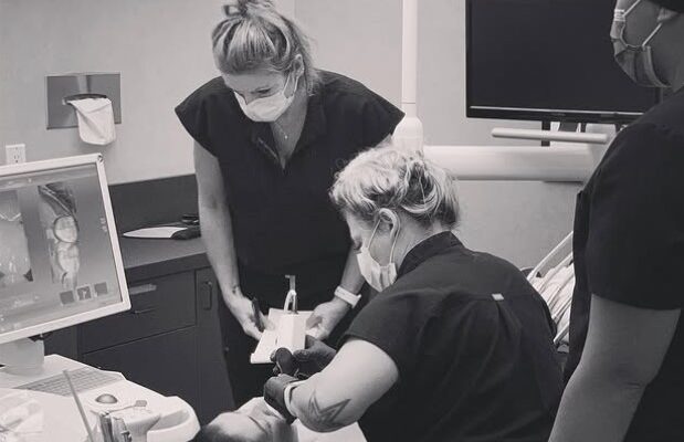 The Oceanside Dental Excellence team scanning a patient's teeth in our office.